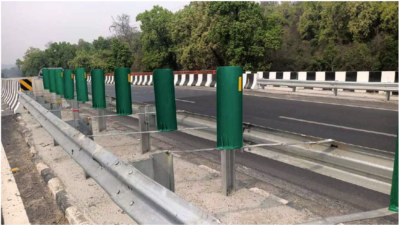 Green anti-glare boards installed on a highway median guardrail